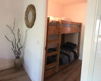 a bunk bed in a room with a mirror at Résidence Fiori di Cala Rossa in Lecci