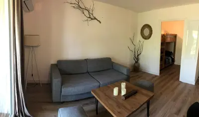 a living room with a couch and a coffee table at Résidence Fiori di Cala Rossa in Lecci