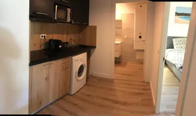 a kitchen with a washer and dryer in a room at Résidence Fiori di Cala Rossa in Lecci
