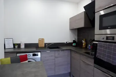 a kitchen with a stove and a counter top at N7 Maison T2 climatisé avec jacuzzi privé in Ajaccio