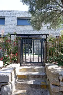a gate to a garden with stairs leading to it at N7 Maison T2 climatisé avec jacuzzi privé in Ajaccio