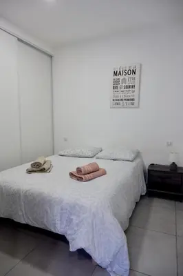 a bedroom with a bed with two towels on it at N8 Maison T2 climatisé in Ajaccio