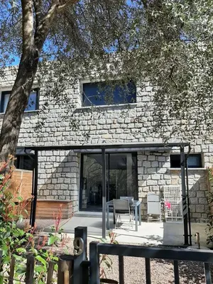 a stone building with a table and chairs in front of it at N9 Maison T2 climatisé in Ajaccio