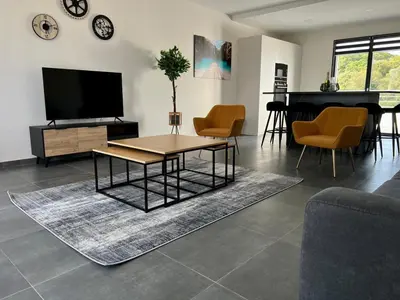 a living room with a television and a table and a piano at Domaine d'Arca - Flaubert 13 - 6 pers in Porto-Vecchio