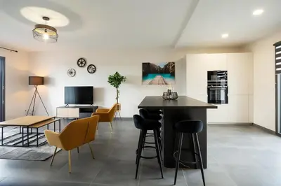 a kitchen and living room with a table and chairs at Domaine d'Arca - Flaubert 13 - 6 pers in Porto-Vecchio