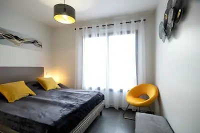 a bedroom with a bed and a large window at Domaine d'Arca - Flaubert 13 - 6 pers in Porto-Vecchio