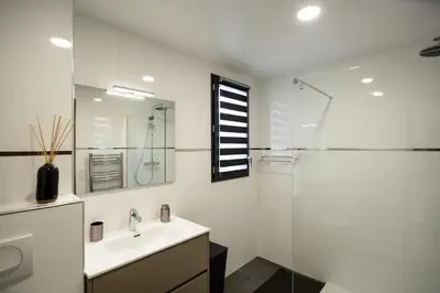 a white bathroom with a sink and a shower at Domaine d'Arca - Flaubert 13 - 6 pers in Porto-Vecchio