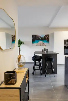 a kitchen and dining room with a table and stools at Domaine d'Arca - Flaubert 13 - 6 pers in Porto-Vecchio