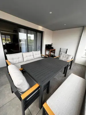 a dining table and chairs in a living room at Domaine d'Arca - Flaubert 13 - 6 pers in Porto-Vecchio
