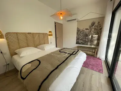 a bedroom with a large bed in a room at Appartement de charme à Propriano, vue sur le Golfe in Viggianello