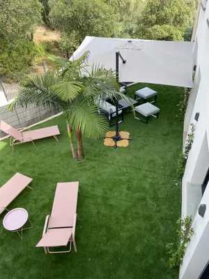 an overhead view of a patio with chairs and a palm tree at Appartement de charme à Propriano, vue sur le Golfe in Viggianello