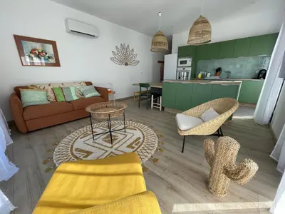 a living room with a couch and a table at Appartement de charme à Propriano, vue sur le Golfe in Viggianello