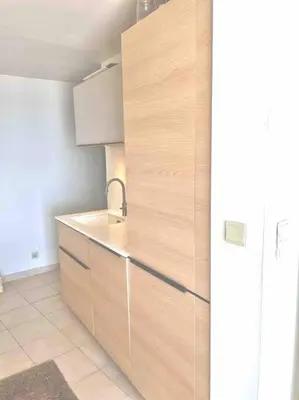 a kitchen with a wooden cabinet with a sink at Casa Altura in Coti-Chiavari