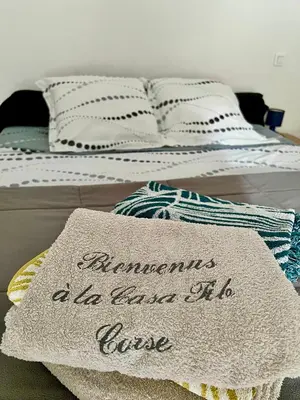 a bed with a mattress with a sign on it at Mini Villa Pascal Paoli avec piscine - proche mer in Prunelli-di-Fiumorbo