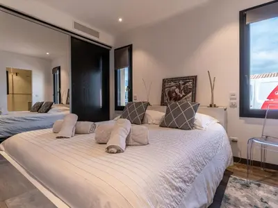 a bedroom with a bed and a large window at Holiday Home Villa les lieges by Interhome in Lecci