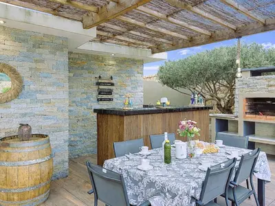 a swimming pool in a backyard with a deck and chairs at Holiday Home Villa les lieges by Interhome in Lecci