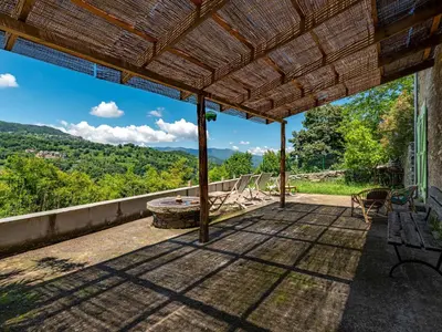 an outdoor patio with a view of the mountains at Holiday Home Maison Penta by Interhome in Penta-di-Casinca