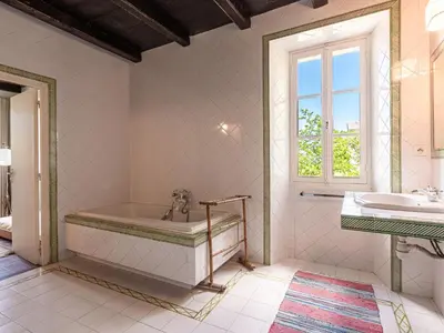a bathroom with a tub and a sink and a window at Holiday Home Maison Penta by Interhome in Penta-di-Casinca
