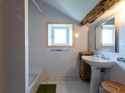 a bathroom with a sink and a bath tub at Holiday Home Maison Penta by Interhome in Penta-di-Casinca