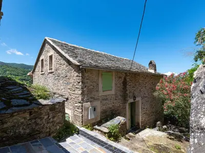 a stone house on the side of a mountain at Holiday Home Maison Penta by Interhome in Penta-di-Casinca