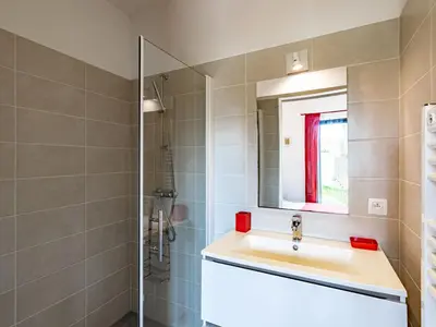a bathroom with a sink and a mirror at Villa Villa Fautea by Interhome in Sainte-Lucie de Porto-Vecchio