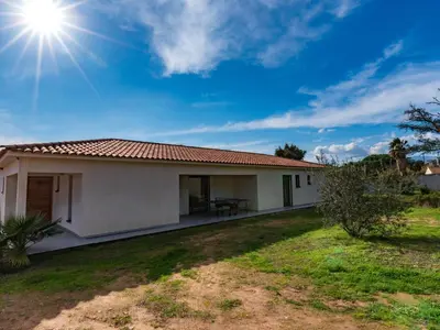 a small white house with the sun in the sky at Villa Villa Fautea by Interhome in Sainte-Lucie de Porto-Vecchio
