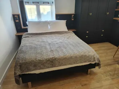 a bed with a blanket and a window in a room at Studio rue Fesch in Ajaccio