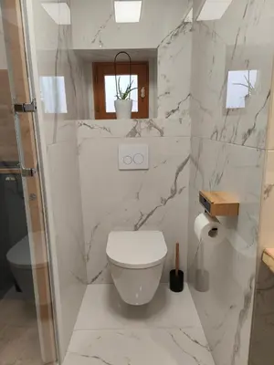 a white bathroom with a toilet and a sink at Studio rue Fesch in Ajaccio