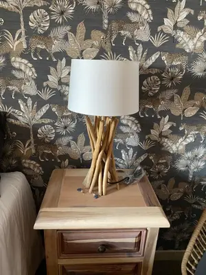 a table with a lamp on a night stand at Villa Corse Vue mer et piscine in Porticcio