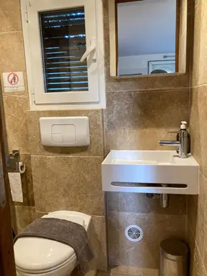 a small bathroom with a toilet and a sink at Locations au centre-ville de Porto-Vecchio, jardin, terrasse, parking privé in Porto-Vecchio