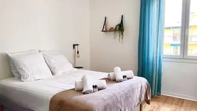 a bedroom with a bed with towels on it at T2 avec balcon au coeur de Ajaccio - Clim & Wifi in Ajaccio