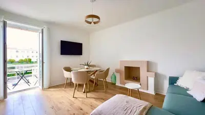 a living room with a blue couch and a table at T2 avec balcon au coeur de Ajaccio - Clim & Wifi in Ajaccio