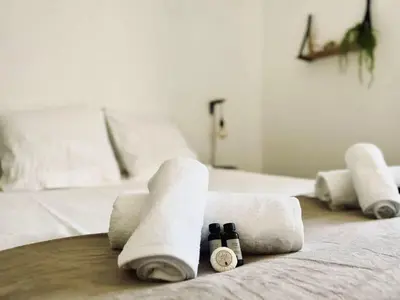 a group of rolled up towels on a bed at T2 avec balcon au coeur de Ajaccio - Clim & Wifi in Ajaccio