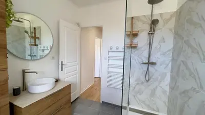 a bathroom with a shower and a sink and a mirror at T2 avec balcon au coeur de Ajaccio - Clim & Wifi in Ajaccio