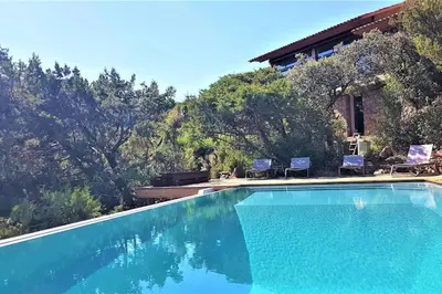 a swimming pool in front of a house at maison-a-sulana-palombaggia in Porto-Vecchio
