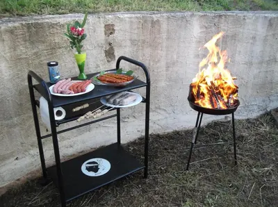 a grill with a plate of food and a fire at Appart 5 personnes a PORTICCIO Avec 2 piscines matériel enfant ,bébé clim in Porticcio
