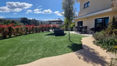 a garden with a lawn and a house at O Ciucciarella - Appt climatisé pour 4 in Grosseto-Prugna
