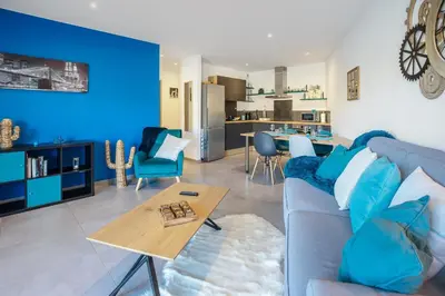 a blue living room with a couch and a table at O Ciucciarella - Appt climatisé pour 4 in Grosseto-Prugna