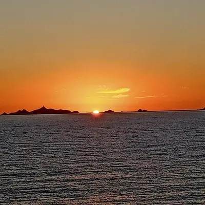 a sunset over a large body of water at Studio climatisée dans résidence à 5 minutes des plages a pied in Propriano