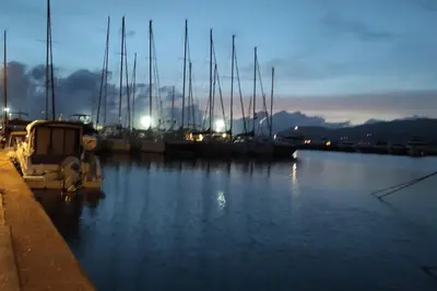 a marina with boats in the water at night at Studio climatisée dans résidence à 5 minutes des plages a pied in Propriano