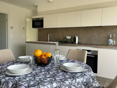 a kitchen with a table with a bowl of fruit on it at La Sté in Porticcio