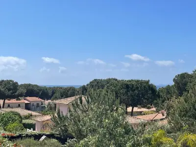 a view of a village with trees and houses at La Sté in Porticcio