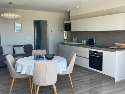 a kitchen and dining room with a table and chairs at La Sté in Porticcio