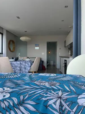a bedroom with a blue and white comforter on a bed at La Sté in Porticcio