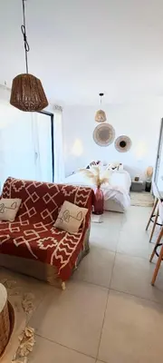 a bedroom with a bed and a couch in it at Appartement Agosta Plage in Porticcio