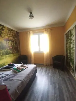 a bedroom with a bed and a window at HAUT VILLA MESANGES EN BORD DE MER ! in Lucciana