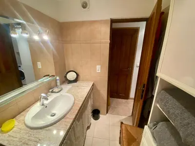 a bathroom with a sink and a mirror at Charmant appartement T2 65m² in Quenza