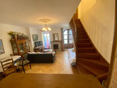 a living room with a staircase leading to a living room at Charmant appartement T2 65m² in Quenza