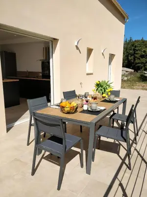 a table and chairs with a bowl of fruit on a patio at Casa voscia in Casalabriva