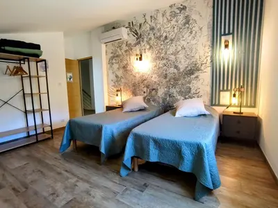 a room with two beds and a wall at Casa voscia in Casalabriva